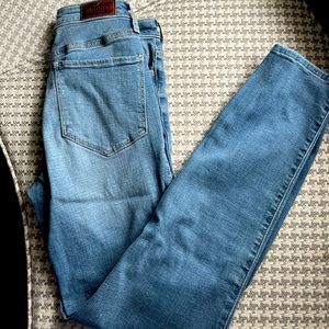 High rise slim straight Jean with cut ripped bottoms